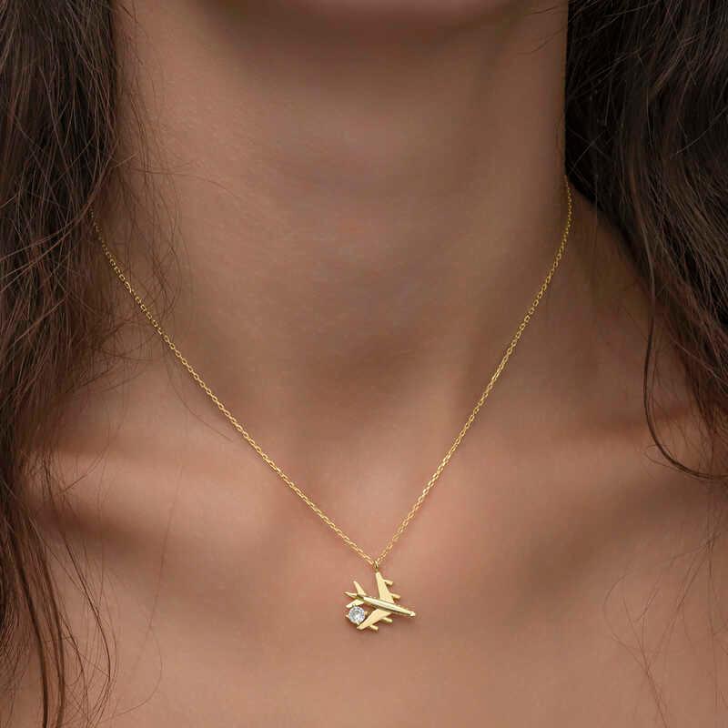 Collier pour femme en argent et or avec une seule pierre représentant un avion