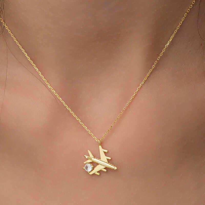 Collier pour femme en argent et or avec une seule pierre représentant un avion