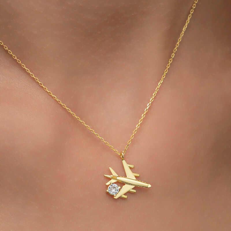 Collier pour femme en argent et or avec une seule pierre représentant un avion