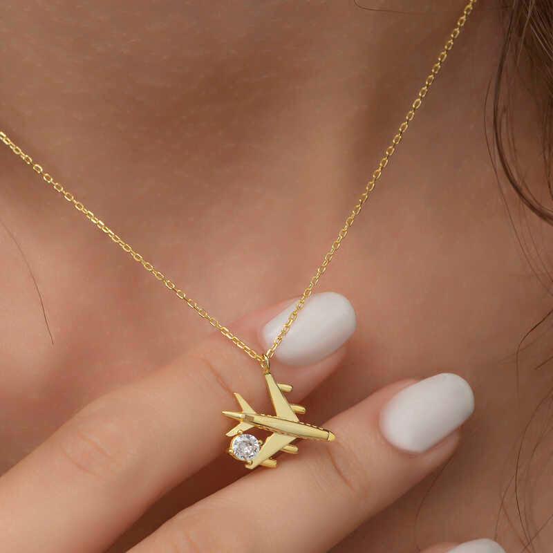 Collier pour femme en argent et or avec une seule pierre représentant un avion