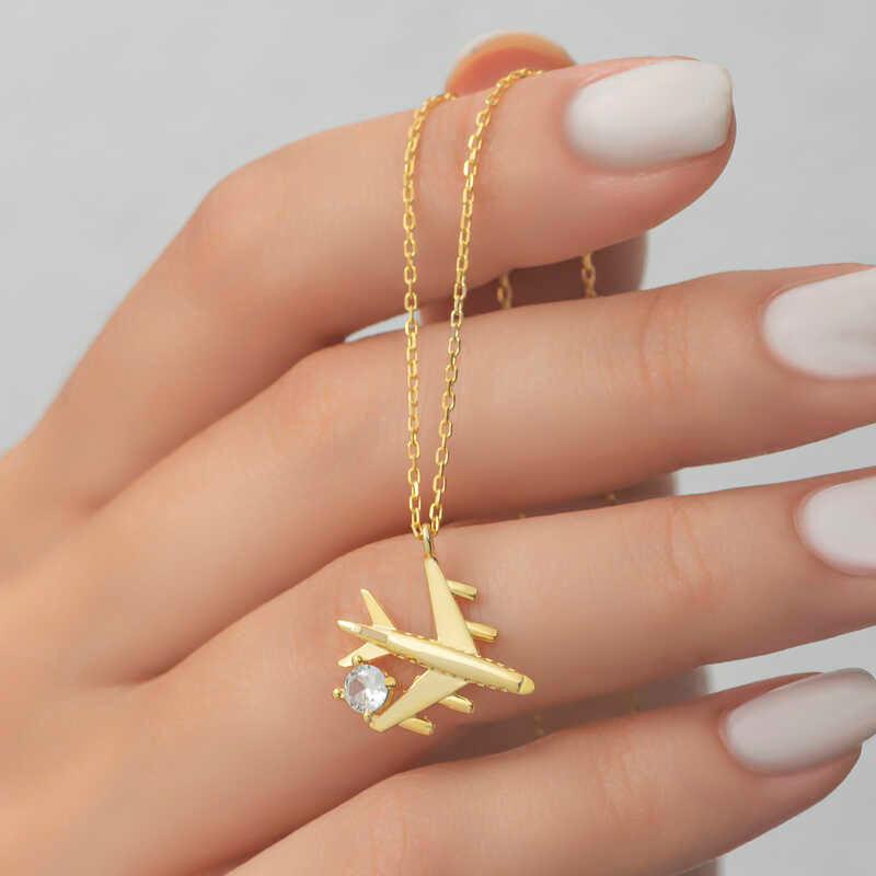 Collier pour femme en argent et or avec une seule pierre représentant un avion